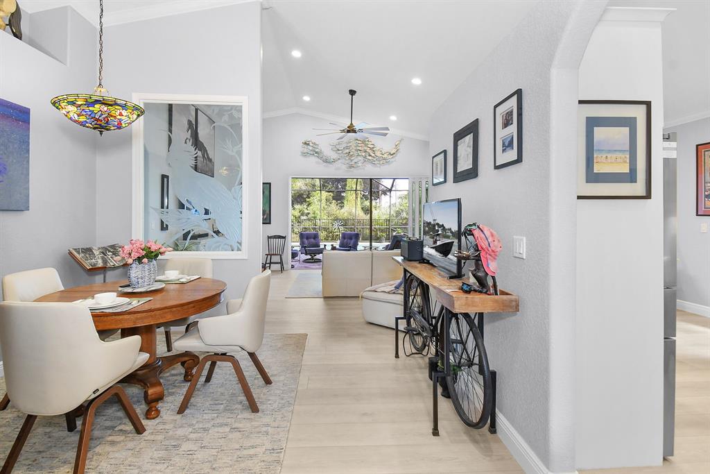 6848 Southeast Twin Oaks Circle Stuart, FL 34997 - Photo 6 of 70 a living room with furniture and a chandelier