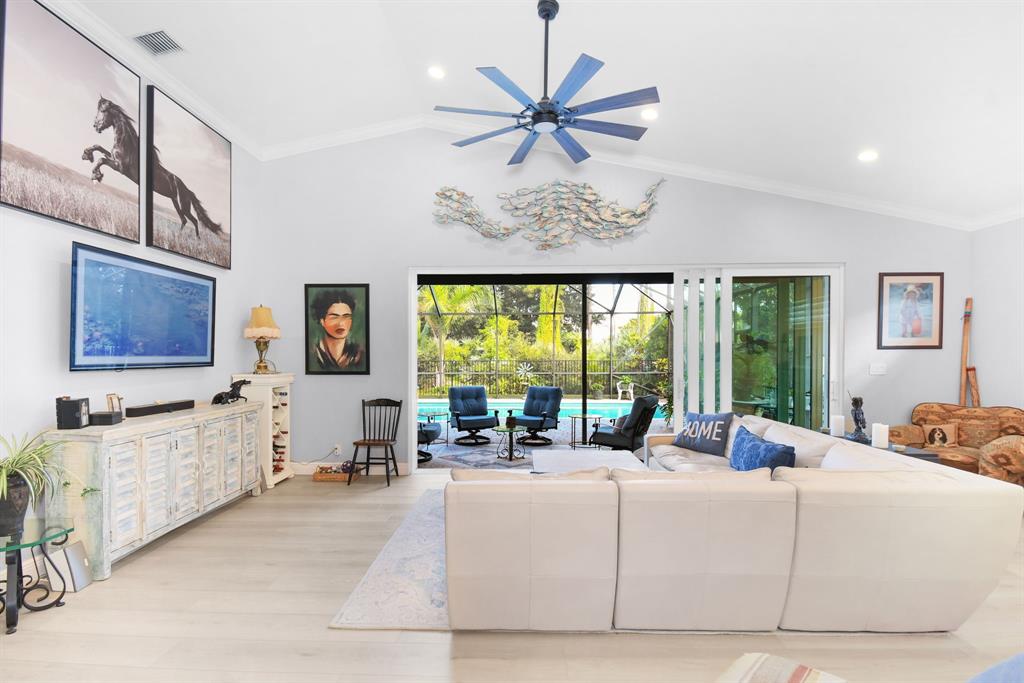 6848 Southeast Twin Oaks Circle Stuart, FL 34997 - Photo 7 of 70 a living room with furniture large window and flat screen tv