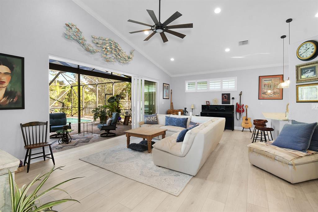 6848 Southeast Twin Oaks Circle Stuart, FL 34997 - Photo 10 of 70 a living room with furniture and a large window
