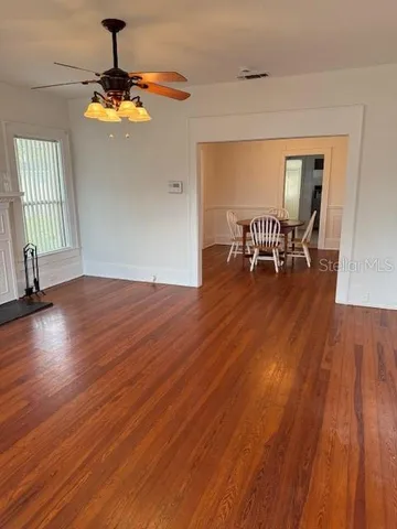wooden floor in an empty room with a window