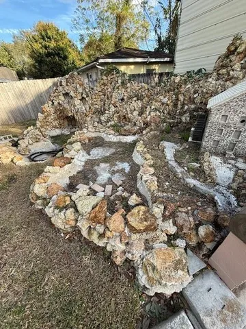 a view of a yard with wooden fence