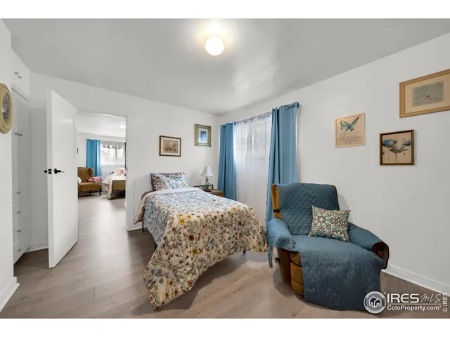 a bedroom with furniture and a wooden floor