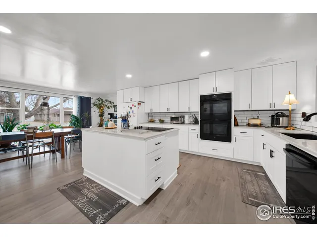 a kitchen with cabinets and wooden floor