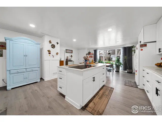 a kitchen with cabinets and wooden floor