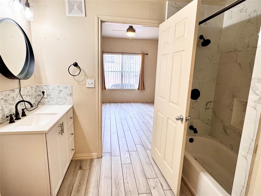 3102 Kings Road, Unit 2106 Dallas, TX 75219 - Photo 14 of 20 a bathroom with a sink a toilet a mirror and shower