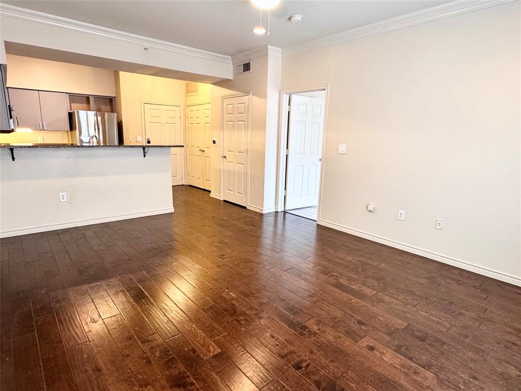 3102 Kings Road, Unit 2106 Dallas, TX 75219 - Photo 2 of 20 a view of a kitchen with a fridge and wooden floor