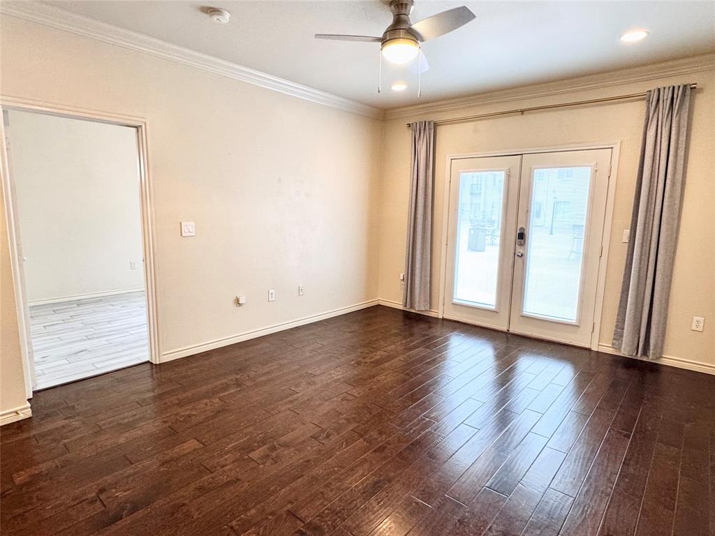 3102 Kings Road, Unit 2106 Dallas, TX 75219 - Photo 3 of 20 an empty room with wooden floor fan and windows