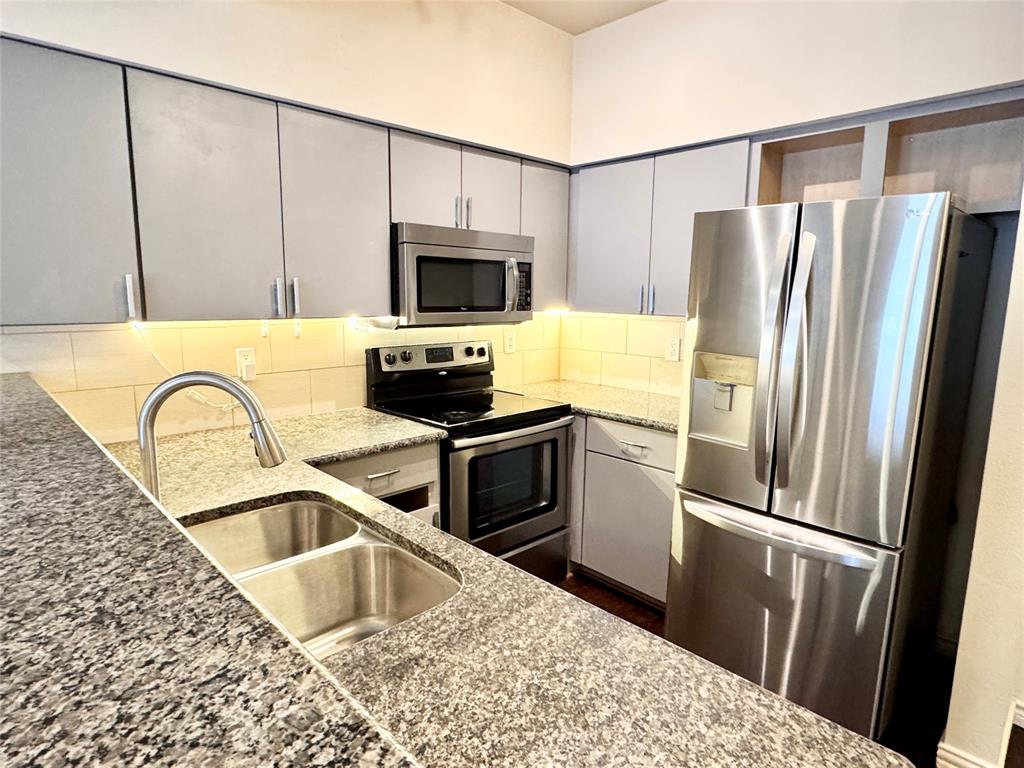 3102 Kings Road, Unit 2106 Dallas, TX 75219 - Photo 7 of 20 a kitchen with a refrigerator stove and sink