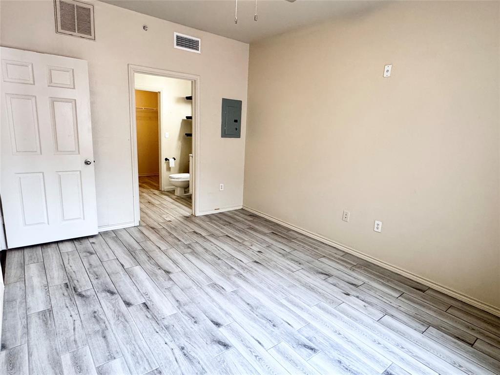 3102 Kings Road, Unit 2106 Dallas, TX 75219 - Photo 10 of 20 a view of a room with wooden floor and gate
