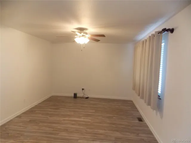 a view of a room with wooden floor