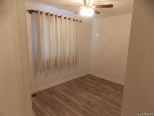 a view of a room with wooden floor