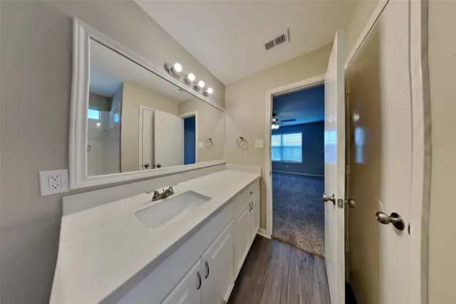 a spacious bathroom with a double vanity sink and mirror