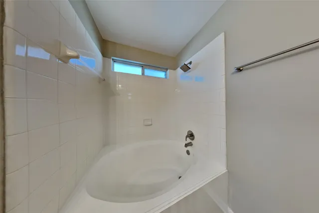 a white bath tub sitting in a bathroom