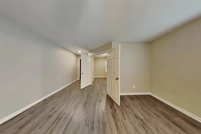 a view of wooden floor and windows in a room
