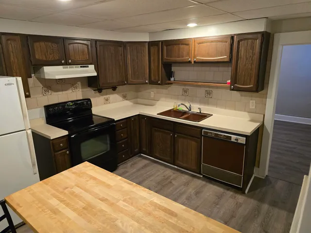 a kitchen with a sink and a stove top oven