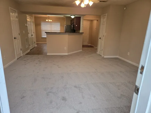 en empty room with kitchen