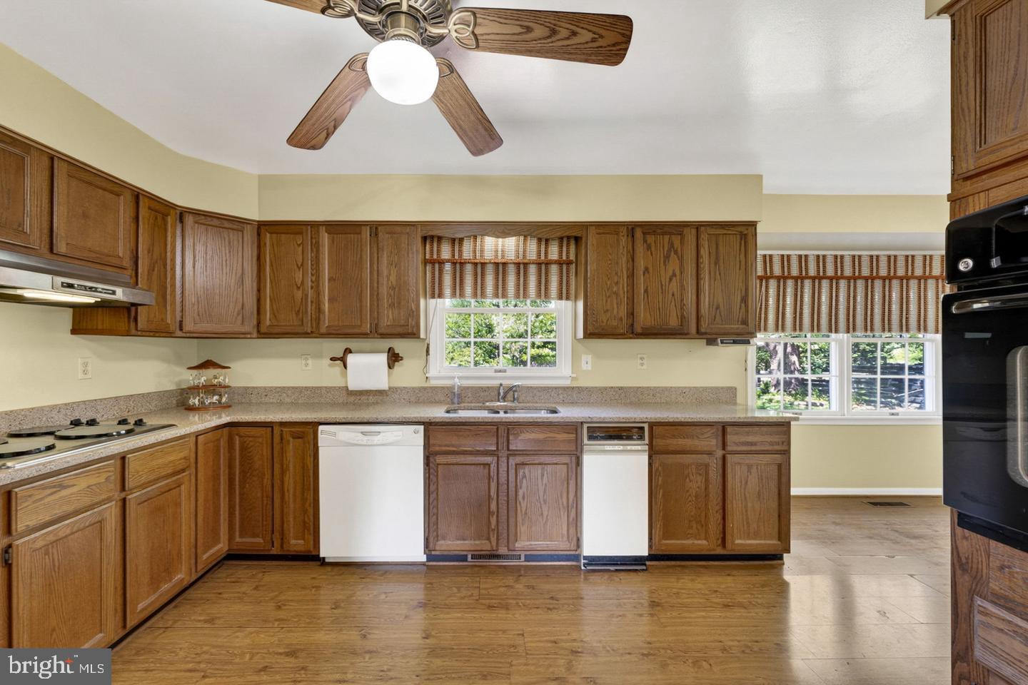 40297 Braddock Road Aldie, VA 20105 - Photo 8 of 34 a kitchen with stainless steel appliances granite countertop a stove a sink and a microwave