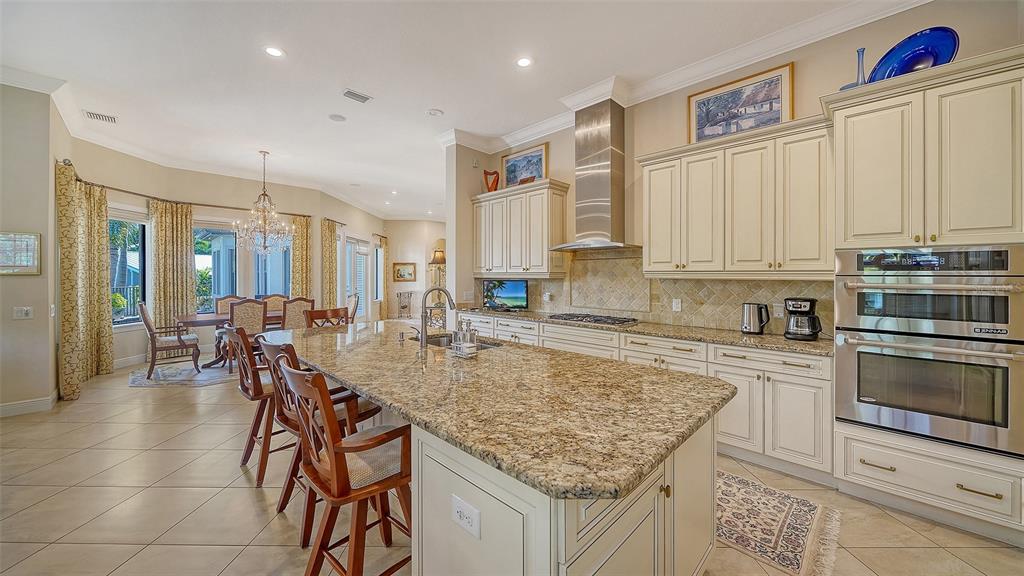 1005 Bogey Lane Longboat Key, FL 34228 - Photo 19 of 69 a kitchen with stainless steel appliances granite countertop a stove top oven a sink counter space and cabinets
