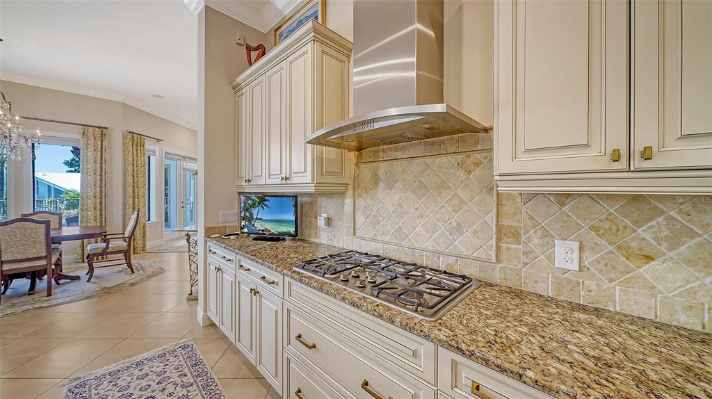 1005 Bogey Lane Longboat Key, FL 34228 - Photo 20 of 69 a kitchen with stainless steel appliances granite countertop a stove a sink and a microwave