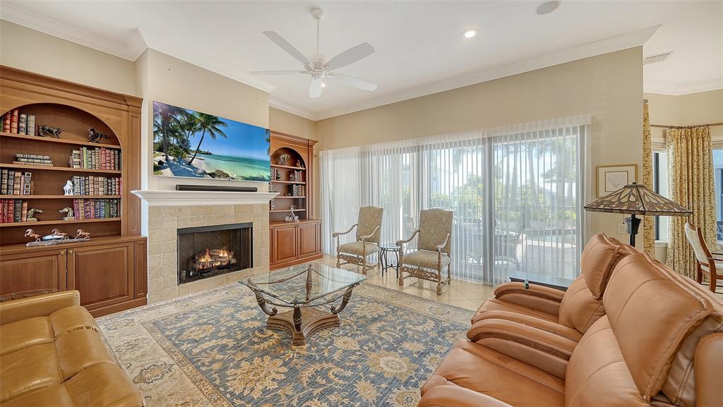 1005 Bogey Lane Longboat Key, FL 34228 - Photo 21 of 69 a living room with furniture fireplace and a large window