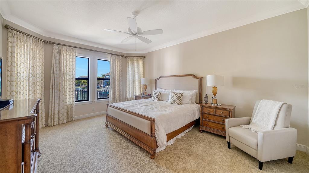 1005 Bogey Lane Longboat Key, FL 34228 - Photo 25 of 69 a bedroom with a bed and a couch