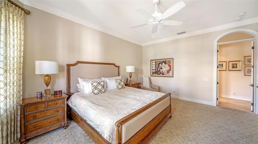 1005 Bogey Lane Longboat Key, FL 34228 - Photo 26 of 69 a bedroom with a bed and a lamp on dresser