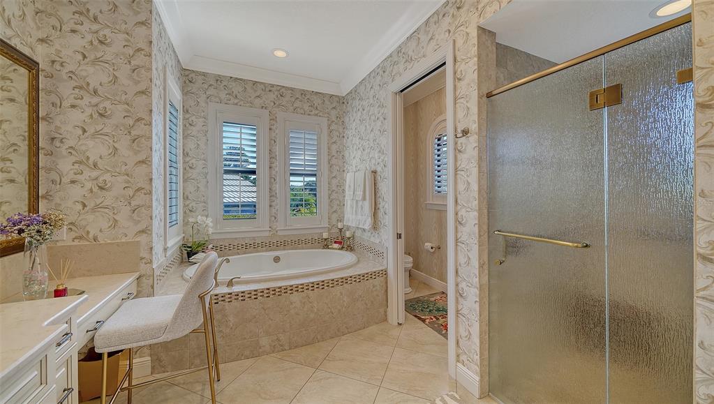 1005 Bogey Lane Longboat Key, FL 34228 - Photo 28 of 69 a spacious bathroom with a tub shower and sink