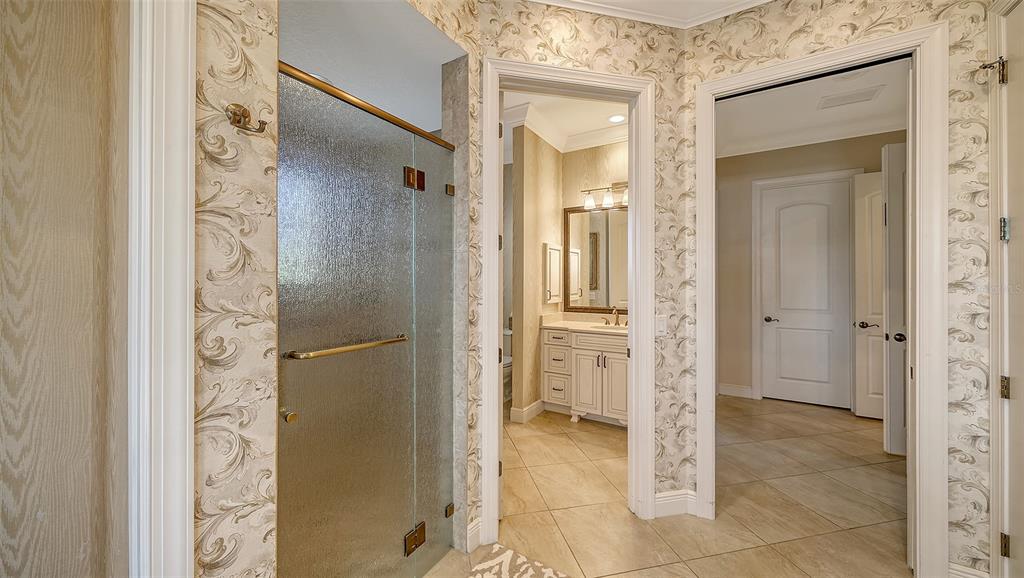 1005 Bogey Lane Longboat Key, FL 34228 - Photo 30 of 69 a bathroom with a glass shower door and a mirror