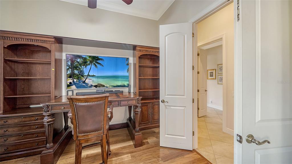 1005 Bogey Lane Longboat Key, FL 34228 - Photo 32 of 69 a view of a dining room with furniture a kitchen and wooden floor