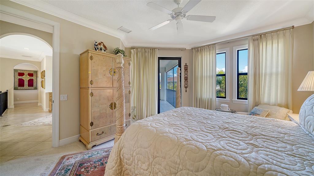 1005 Bogey Lane Longboat Key, FL 34228 - Photo 43 of 69 a bedroom with a bed and a large mirror