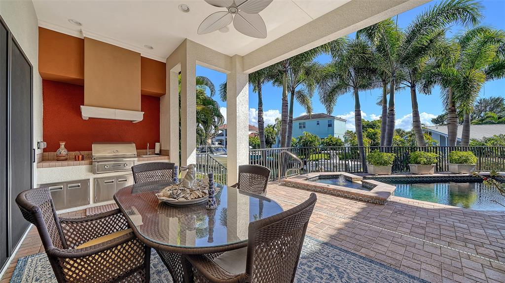 1005 Bogey Lane Longboat Key, FL 34228 - Photo 47 of 69 a view of a patio with couches chairs dining table and chairs