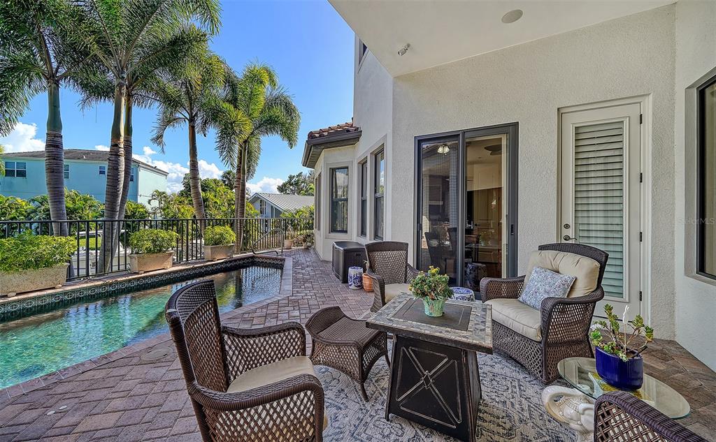 1005 Bogey Lane Longboat Key, FL 34228 - Photo 52 of 69 a view of a patio with couches table and chairs and potted plants