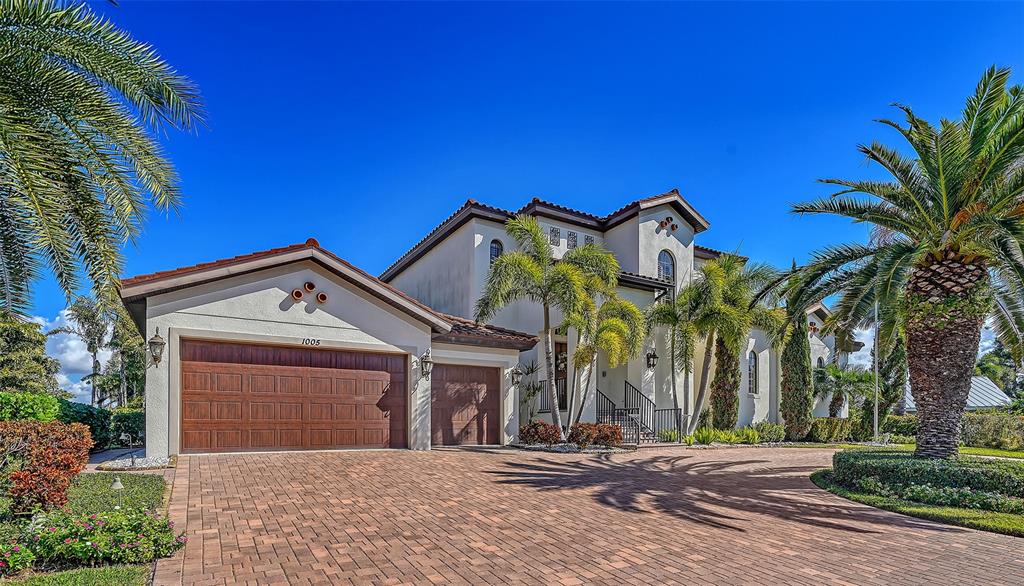 1005 Bogey Lane Longboat Key, FL 34228 - Photo 9 of 69 a front view of a house with a yard