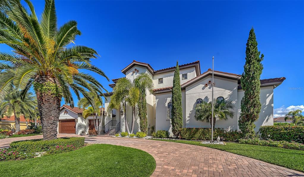 1005 Bogey Lane Longboat Key, FL 34228 - Photo 10 of 69 a view of a house with a yard and palm trees