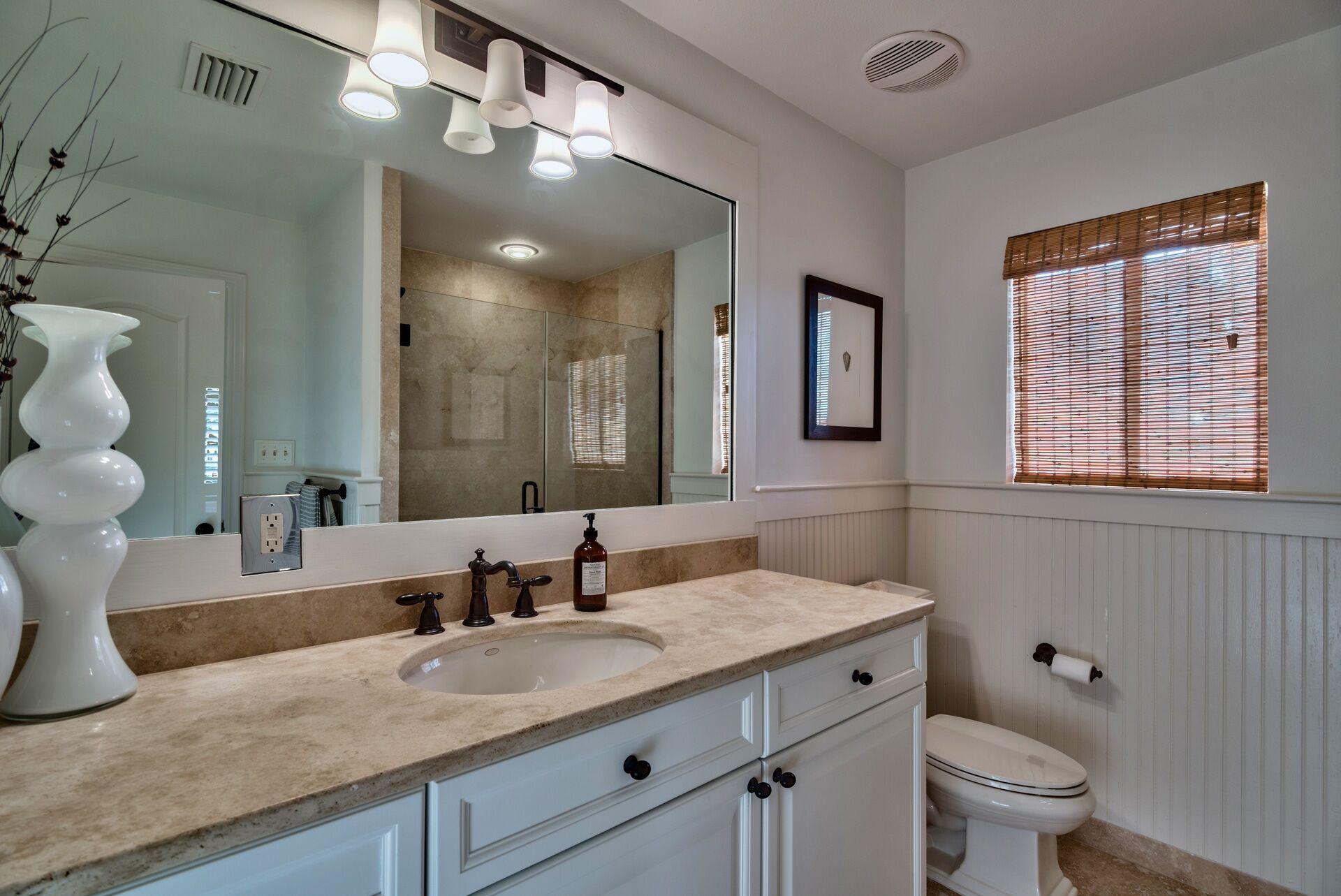 134 My Way Santa Rosa Beach, FL 32459 - Photo 33 of 48 a bathroom with a granite countertop sink a toilet and a mirror