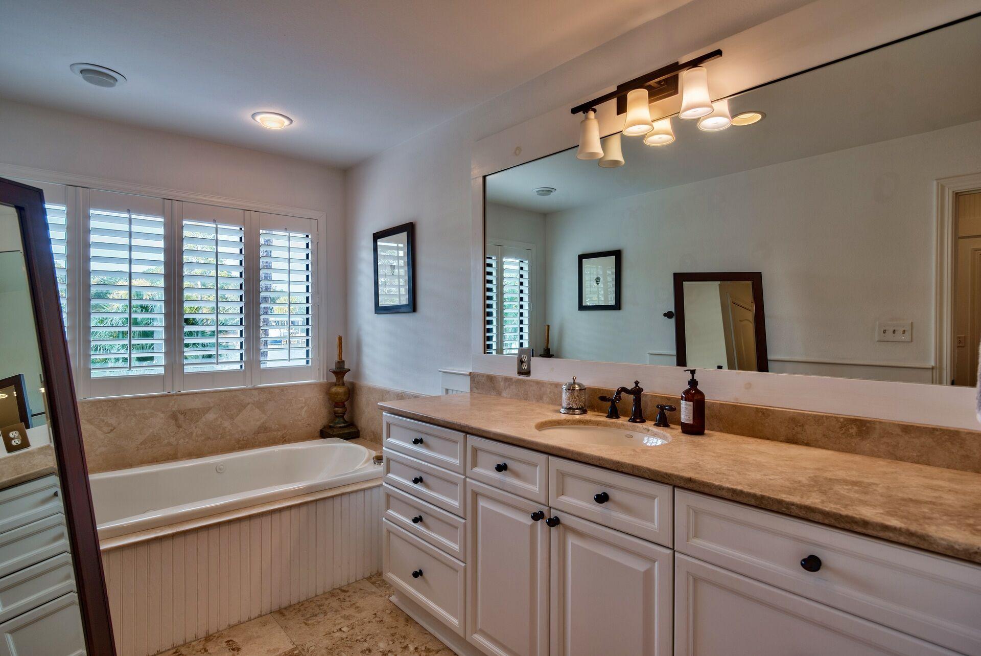 134 My Way Santa Rosa Beach, FL 32459 - Photo 35 of 48 a bathroom with a tub a sink and large mirror