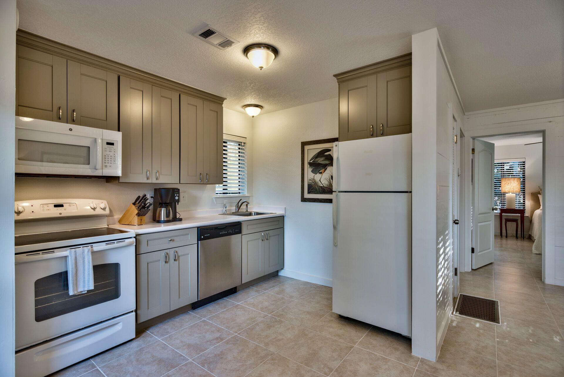 134 My Way Santa Rosa Beach, FL 32459 - Photo 45 of 48 a kitchen with stainless steel appliances granite countertop a refrigerator a stove a sink and a microwave