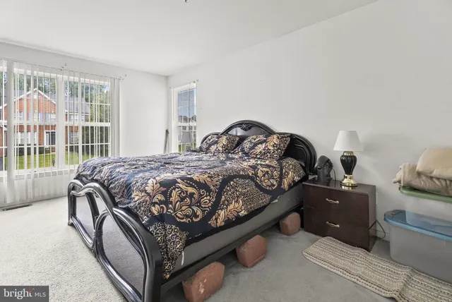 a bed sitting in a bedroom next to a window