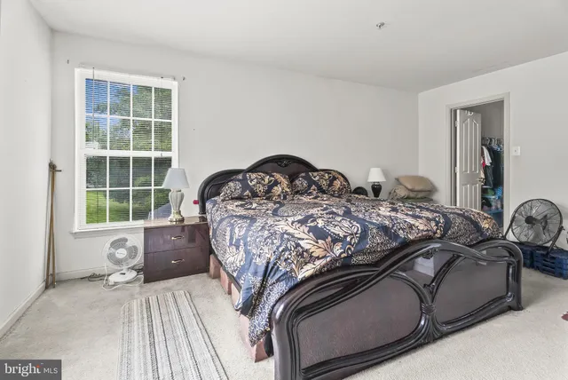 a bed sitting in a bedroom next to a window