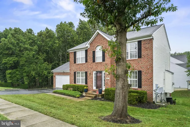 front view of a house next to a yard
