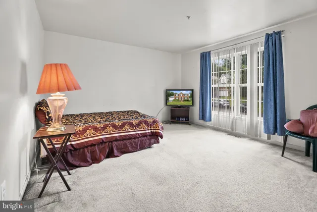 a bed room with a bed and a chair