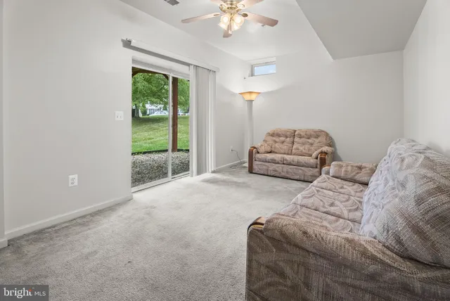 a spacious bedroom with a bed and a chandelier
