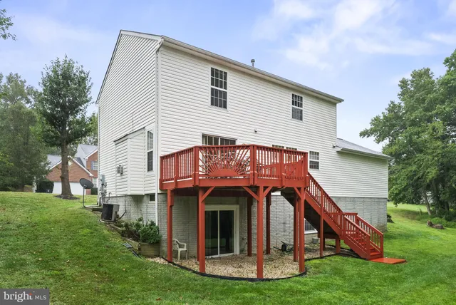 a view of a house with a small yard plants and large tree