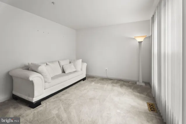 a living room with furniture and a lamp