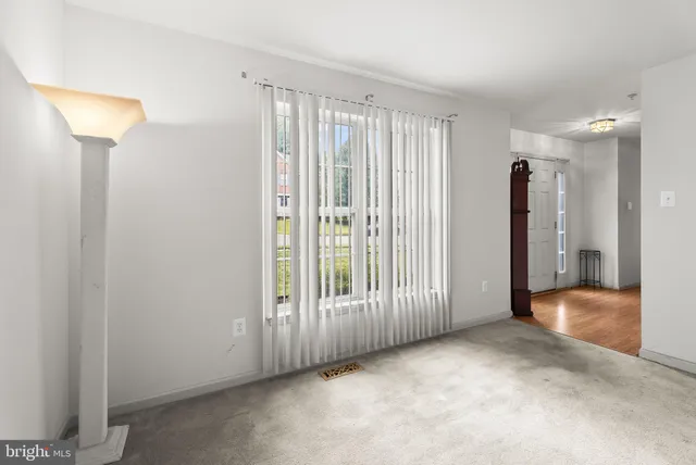 an empty room with windows and gate