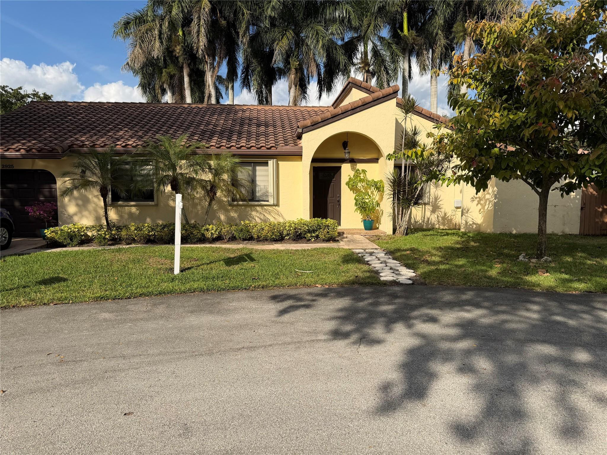 2925 Azalea Drive Hollywood, FL 33026 - Photo 13 of 13 a view of a white house with a large trees