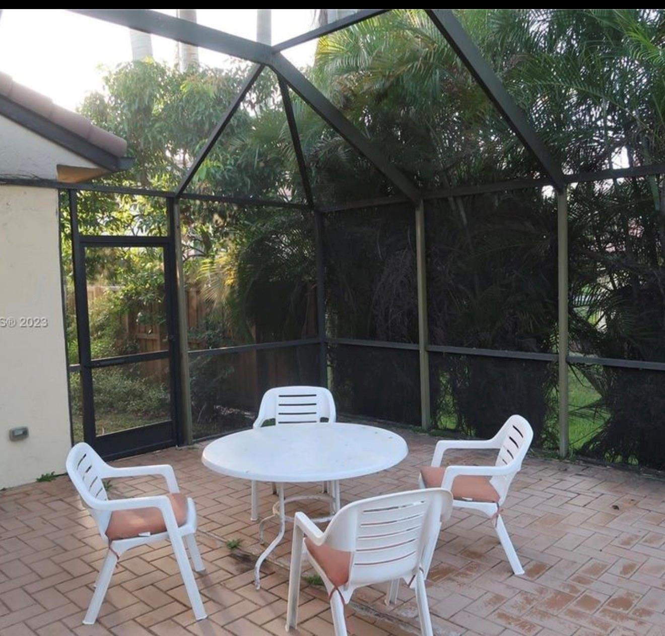 2925 Azalea Drive Hollywood, FL 33026 - Photo 4 of 13 a view of a table and chairs in the patio