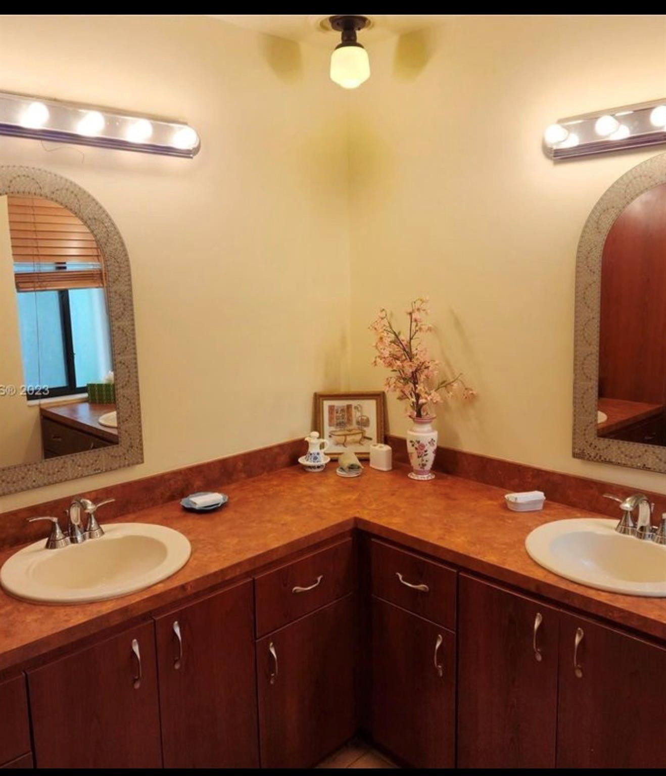 2925 Azalea Drive Hollywood, FL 33026 - Photo 9 of 13 a bathroom with a granite countertop sink a large mirror and vanity