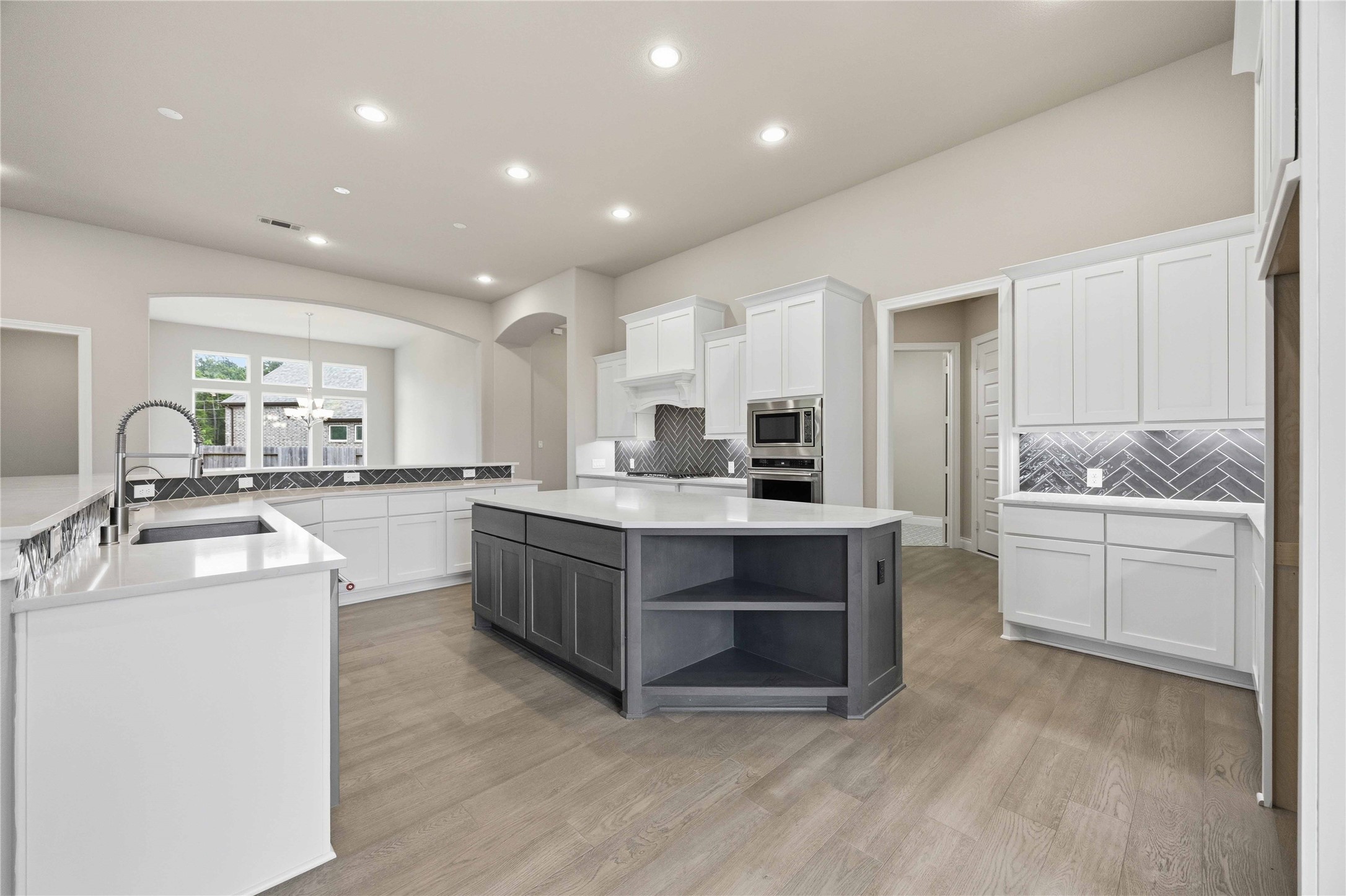 17564 Watercolor Way Conroe, TX 77302 - Photo 15 of 42 Chef's kitchen with quartz counter tops, stylish backsplash, expansive island, stainless steel appliances and walk in pantry