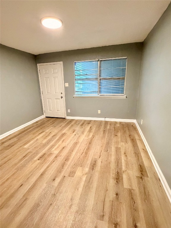 9100 Dodson Street, Unit 19 Houston, TX 77093 - Photo 3 of 16 an empty room with wooden floor windows and closet